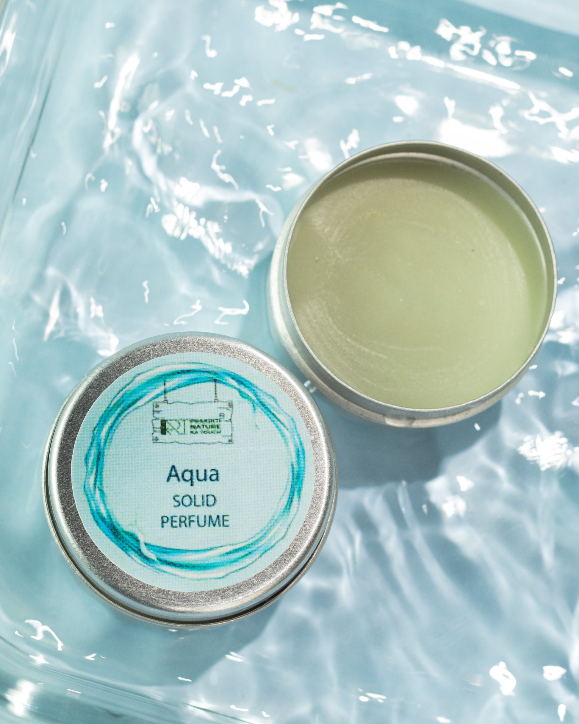 PNKT Natural Solid Perfume - Aqua scent variant with water elements in background - Fresh aquatic fragrance