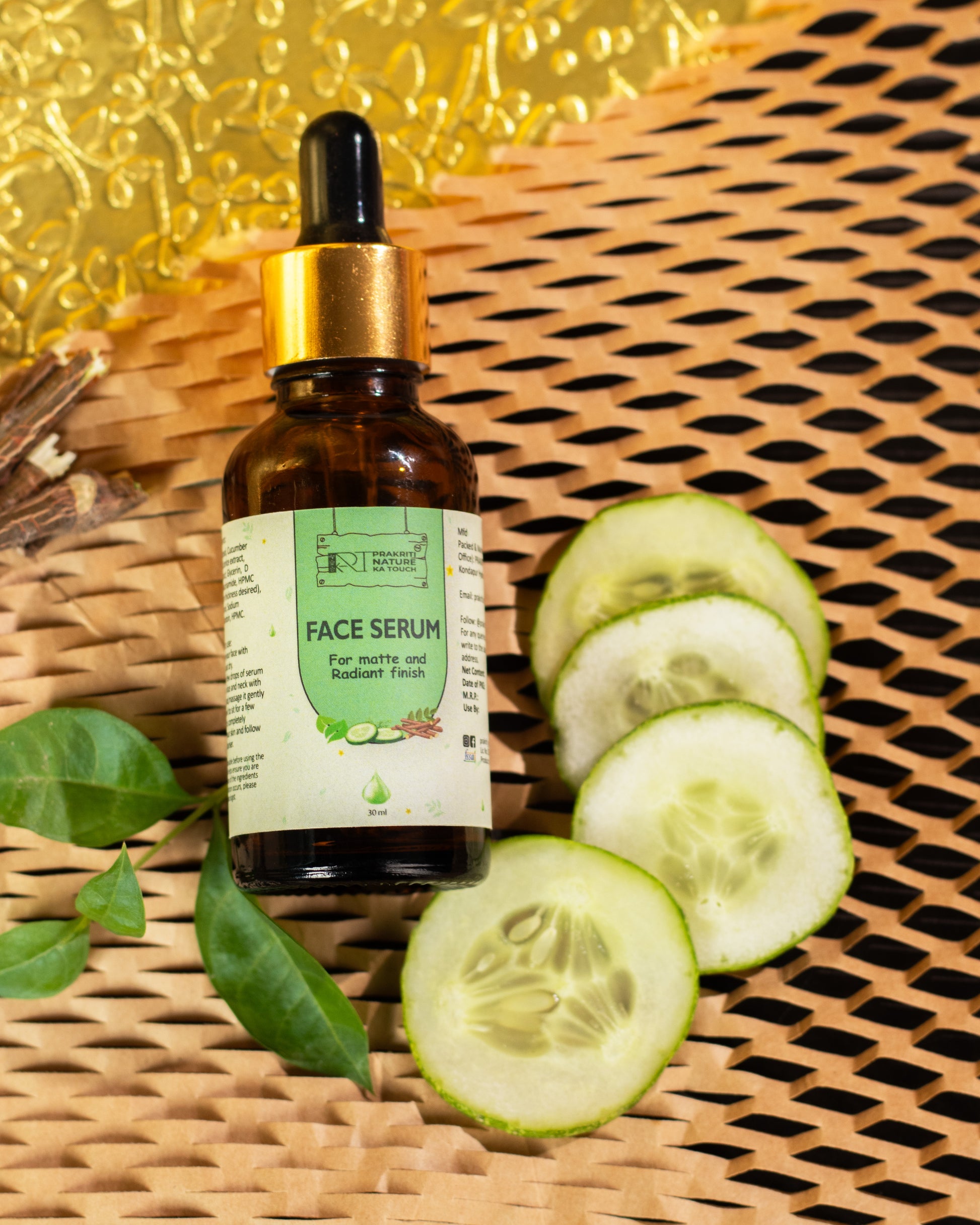 PNKT Natural Face Serum - Lifestyle shot showing serum bottle surrounded by fresh tea tree leaves and cucumber - Natural skincare routine
