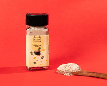 PNKT Natural Dusting Powder - Talc-free body powder jar on red background - 50g