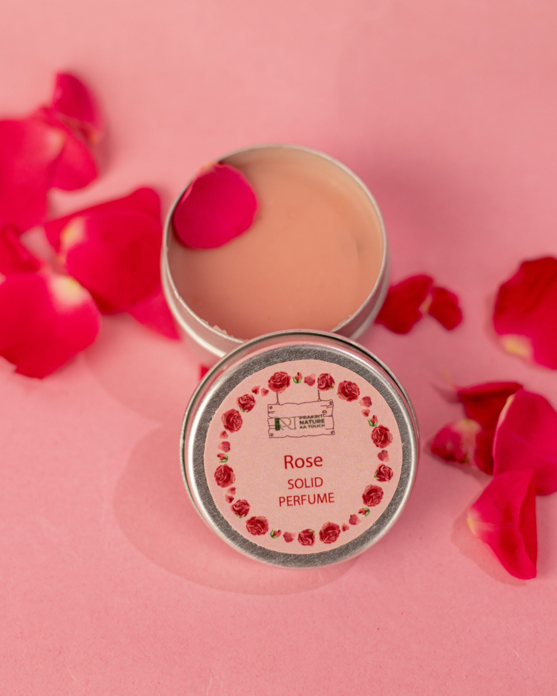 PNKT Natural Solid Perfume - Rose scent variant with rose petals in background - Romantic floral fragrance