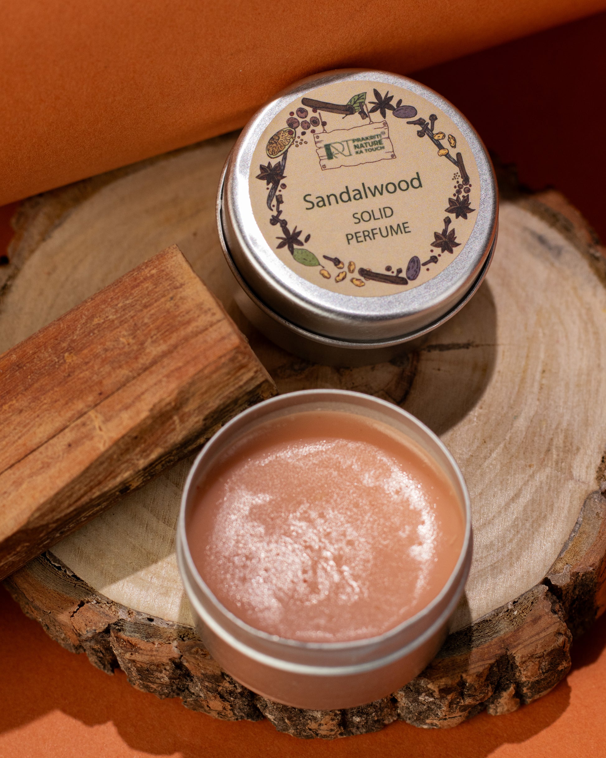 PNKT Natural Solid Perfume - Sandalwood scent variant with wood elements in background - Warm woody fragrance