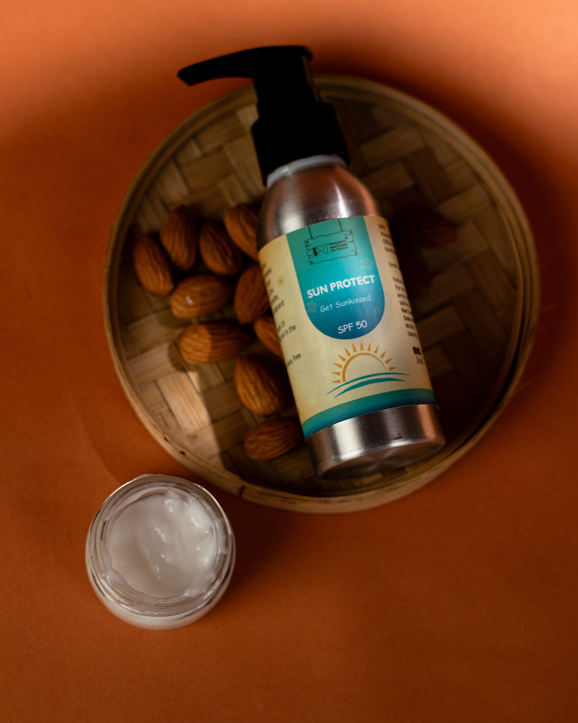 PNKT Natural Sunscreen Cream - SPF 50 tube with almonds in the background - Broad spectrum UV protection